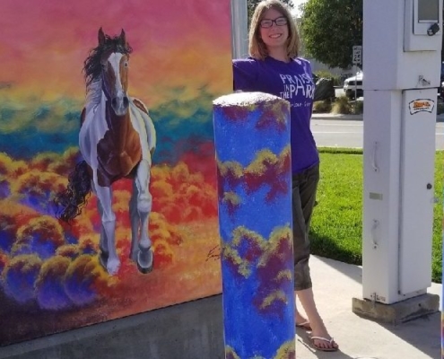 utility-box-and-student-e1548782044763 Photo of Emma S. with her painted utilities box in Brentwood