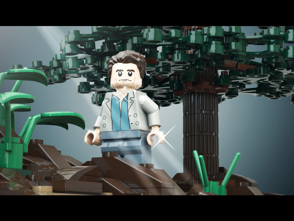 Lego figure of Edward from Twilight. Male lego with dark hair poses in front of a tree.