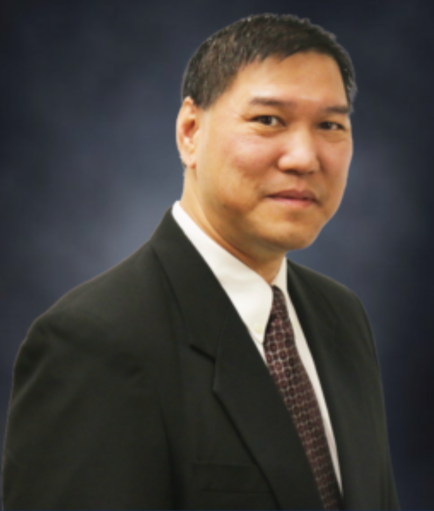 Clark, a Visions board member, smiling in a suit and tie