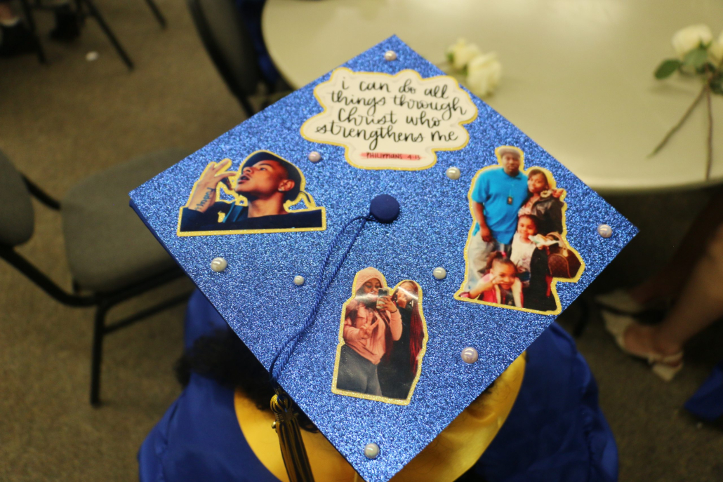 Graduation cap decorated with photos and a bible script.