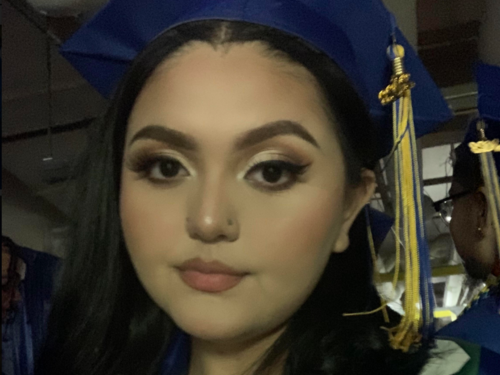 Dulce S web Selfie of a teenage girl in a blue graduation cap with blue and gold tassel.
