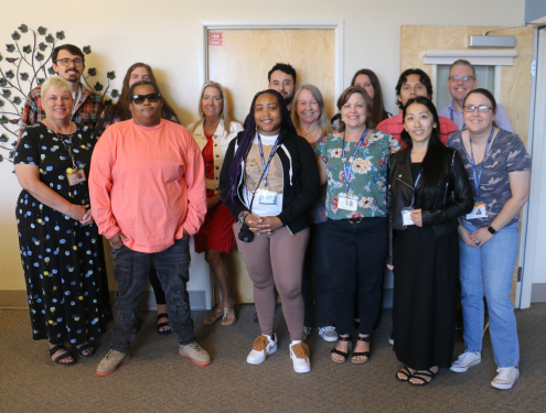 The Attendance & Records team gathers together in the Visions office for a group photo.
