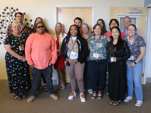 The Attendance & Records team gathers together in the Visions office for a group photo.