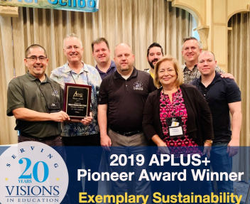 Visions staff accepts award at APLUS+ conference