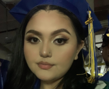 Selfie of a teenage girl in a blue graduation cap with blue and gold tassel.