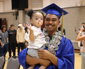 High school graduate celebrates at summer graduation after catching up on credits