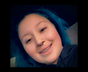 Online high school student Alyssa smiles at the camera, working on CTE health courses and earning high school diploma