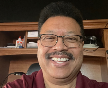 Visions In Education special education teacher, Ken, smiles at the camera