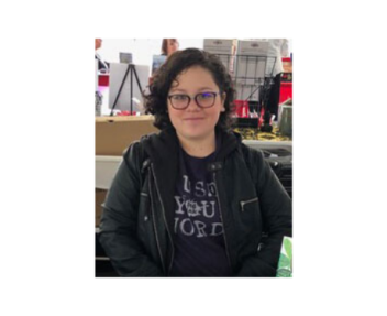 Female student smiles at the camera