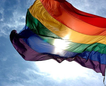 Rainbow_flag_and_blue_skies