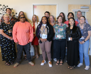 The Attendance & Records team gathers together in the Visions office for a group photo.