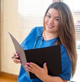 Happy female high school student learning about healthcare in career technical education program reading file