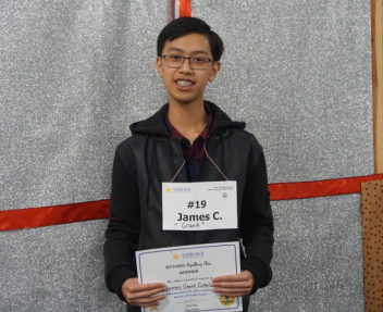 Male student smiles at the camera after winning the spelling bee