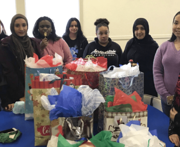 Photos of students with wrapped presents for charity