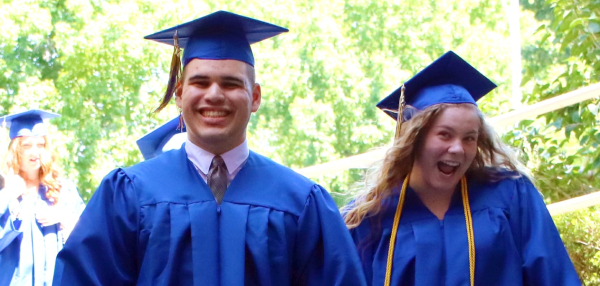 A group of smiling graduates of Visions In Education smiling