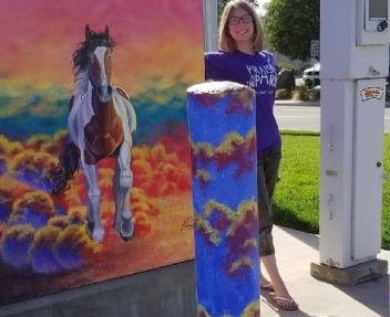Photo of Emma S. with her painted utilities box in Brentwood